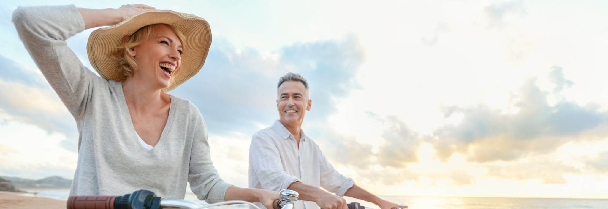 couple riding bikes on the beach